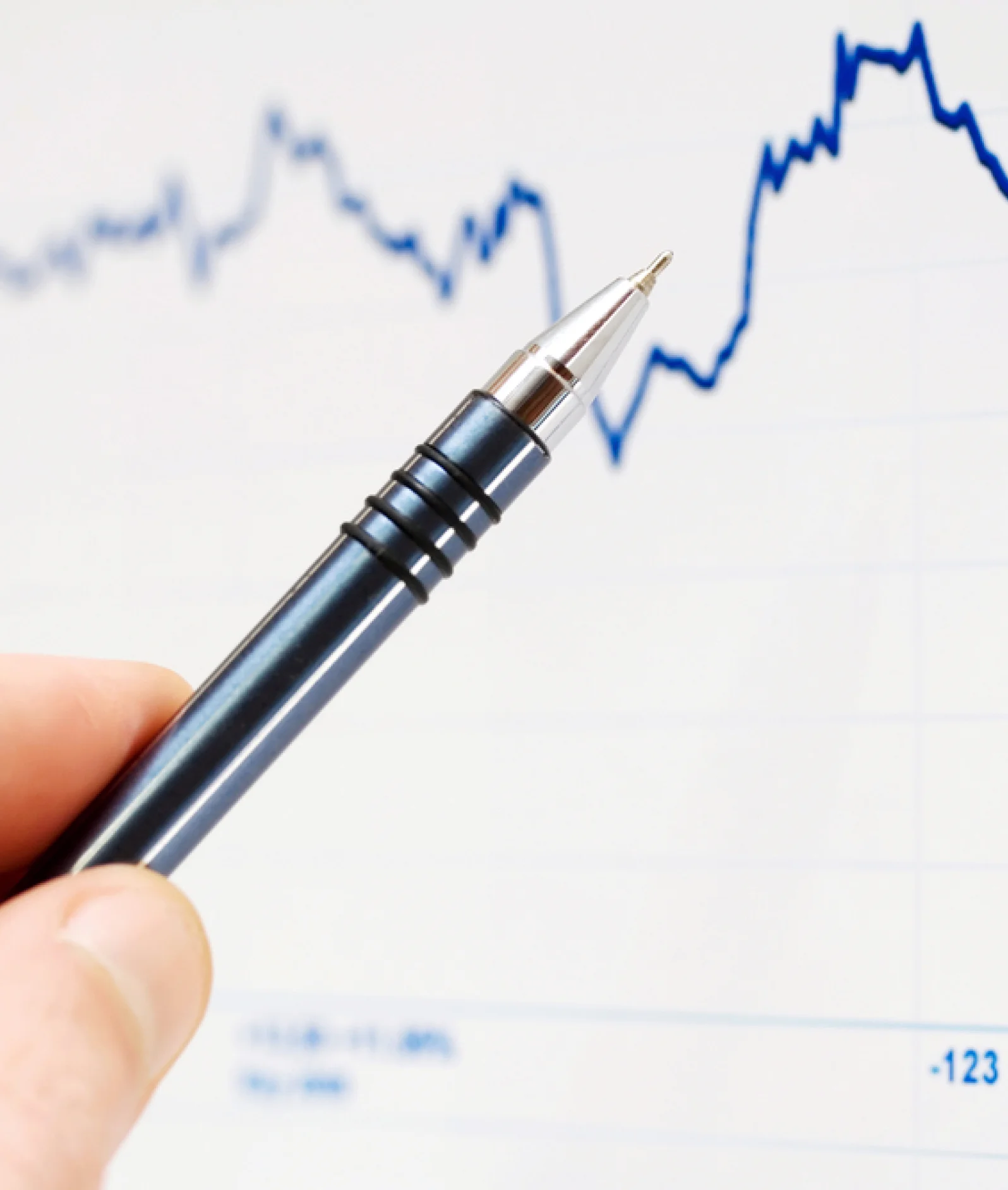 Pen pointing towards a computer graph line