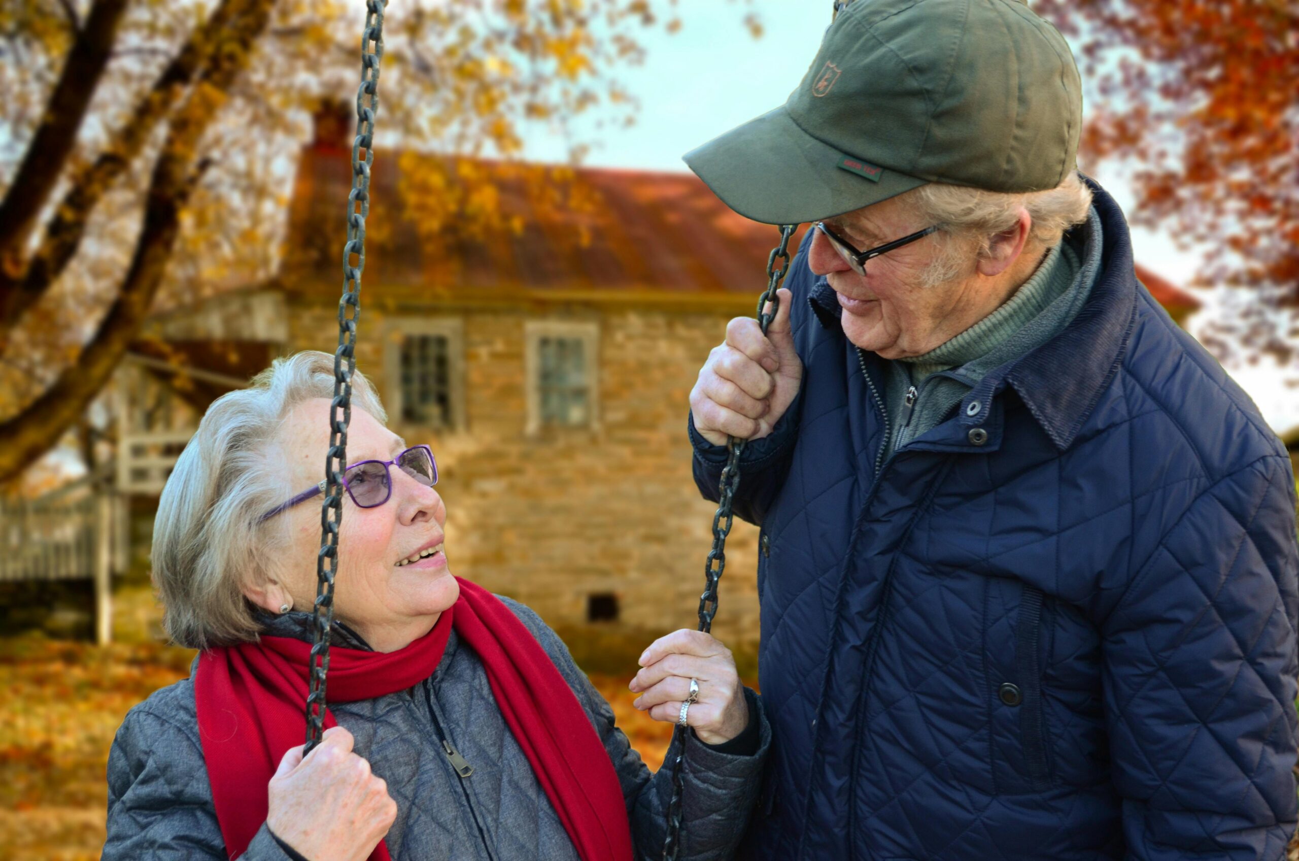 Elderly man and woman by a swingset