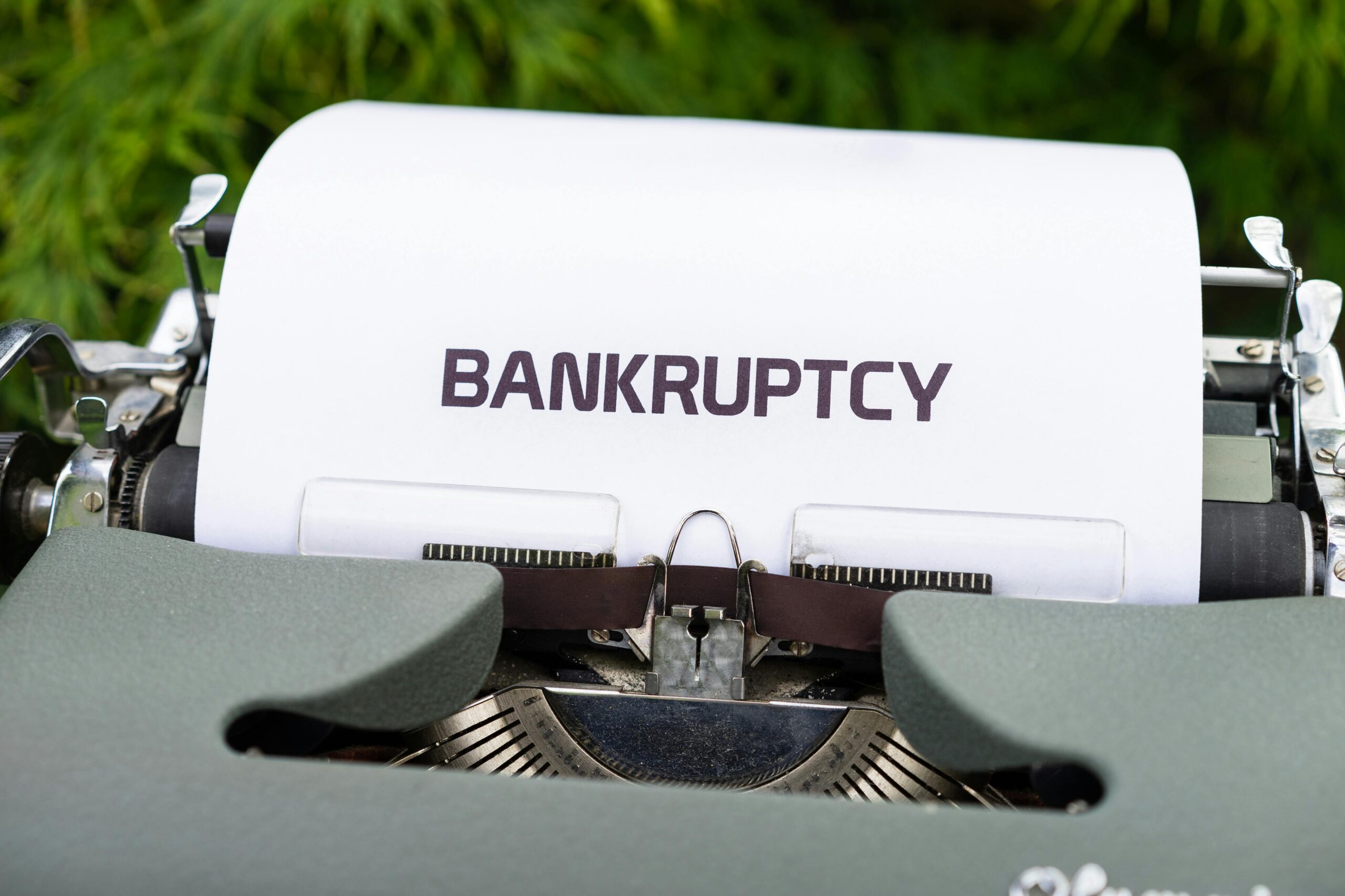 The word "Bankruptcy" typed on a piece of paper coming out of a typewriter